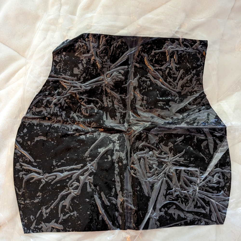 Latex mini skirts still in its sealed wrap. Size M
